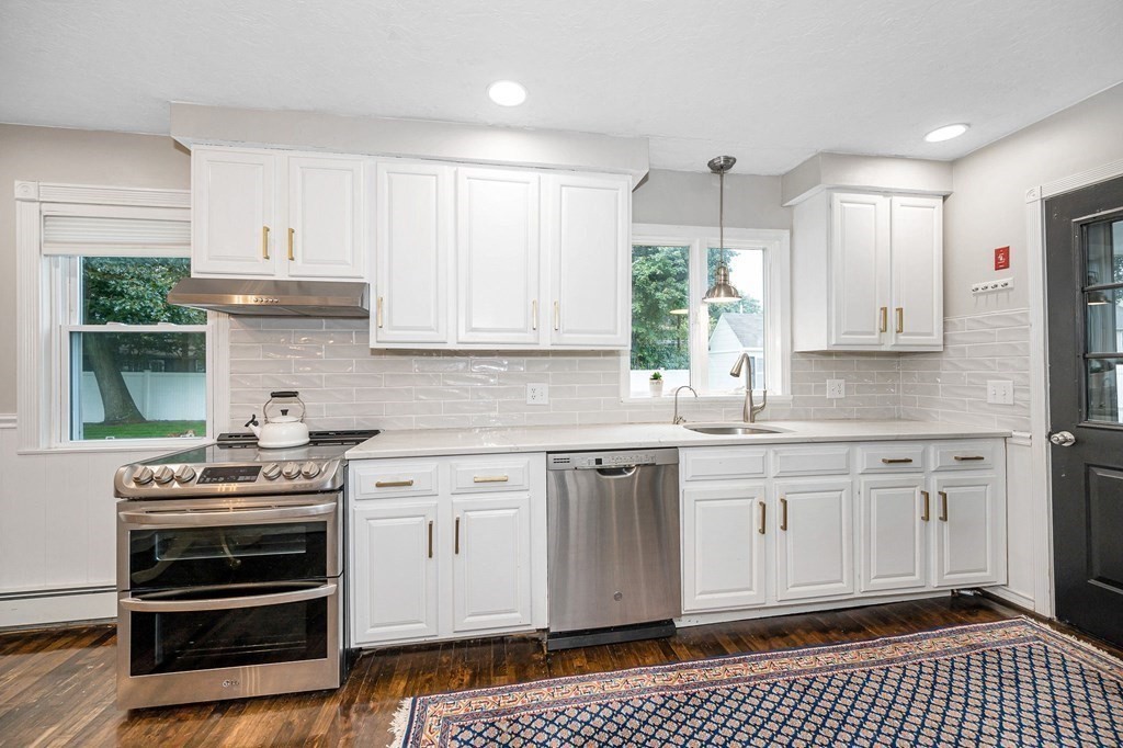 21 Sherwood Road Wilmington, MA 01887 - Photo 11 of 42 a kitchen with stainless steel appliances a stove a sink and cabinets