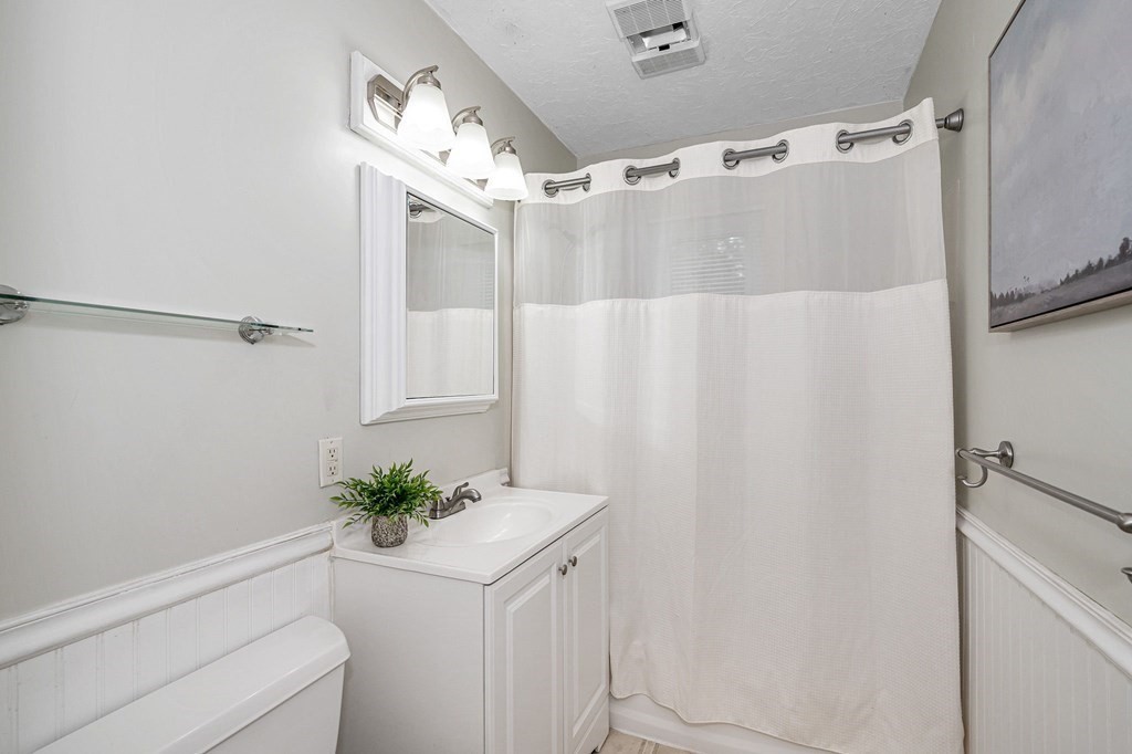 21 Sherwood Road Wilmington, MA 01887 - Photo 14 of 42 a bathroom with a shower curtain and a mirror