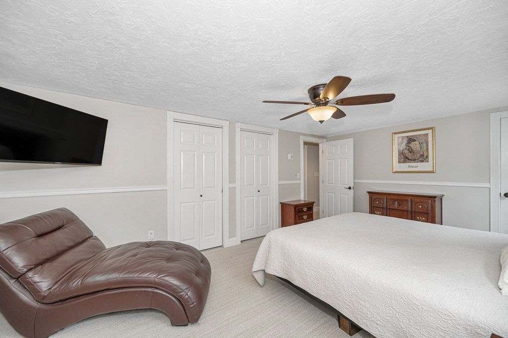 21 Sherwood Road Wilmington, MA 01887 - Photo 19 of 42 a bedroom with a bed and a flat screen tv