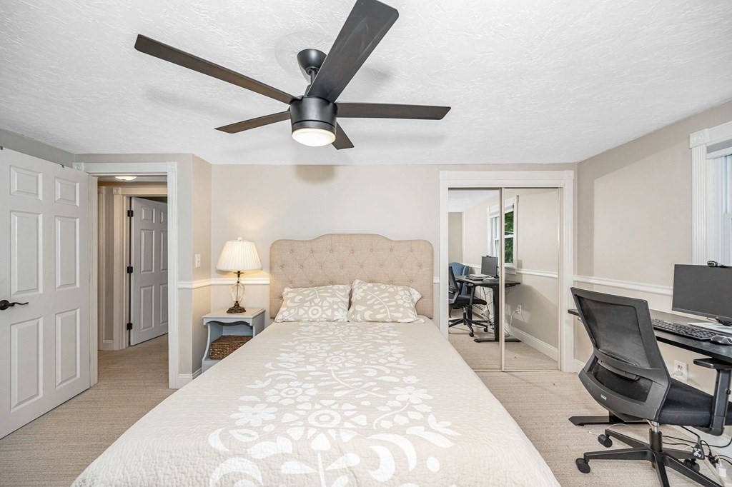 21 Sherwood Road Wilmington, MA 01887 - Photo 27 of 42 a bedroom with a bed a desk and chair with wooden floor
