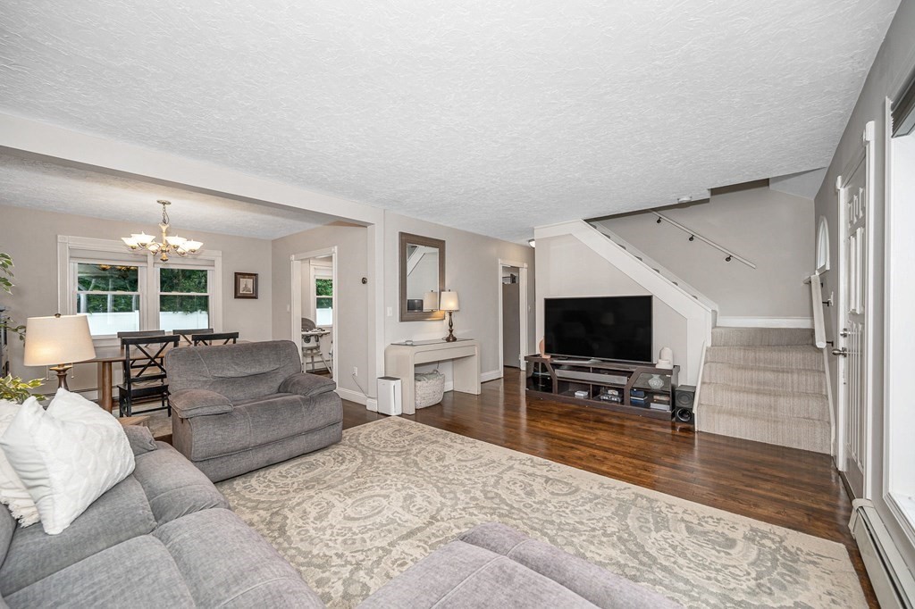 21 Sherwood Road Wilmington, MA 01887 - Photo 7 of 42 a living room with furniture and a flat screen tv
