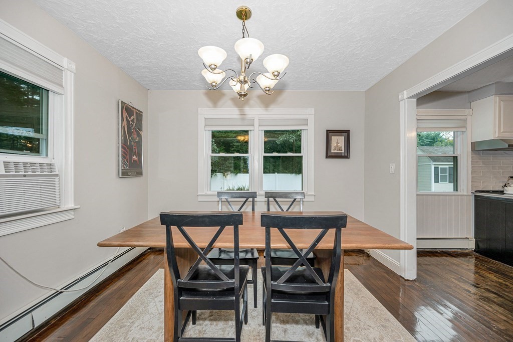 21 Sherwood Road Wilmington, MA 01887 - Photo 8 of 42 a view of a dining room with furniture and wooden floor