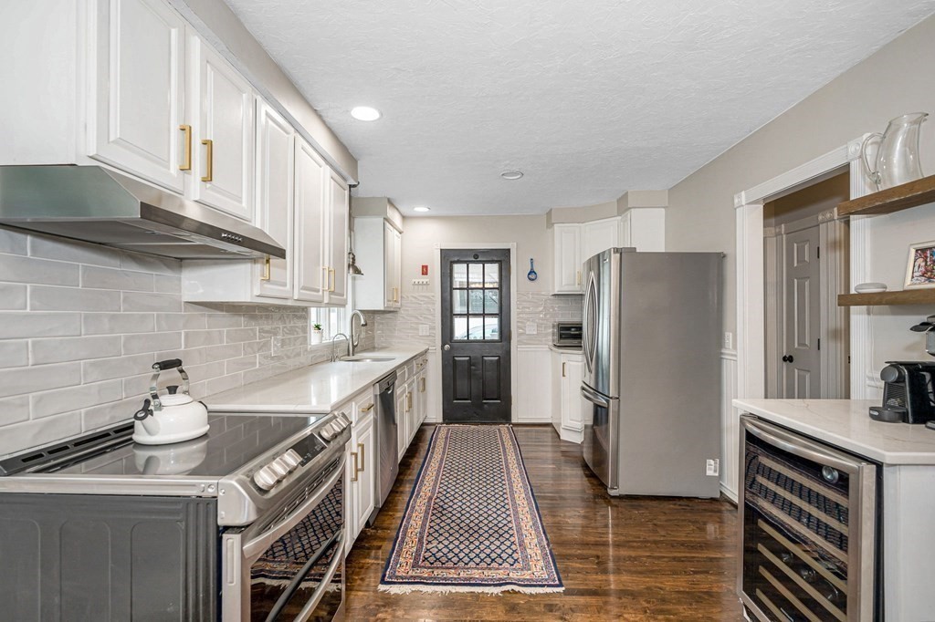 21 Sherwood Road Wilmington, MA 01887 - Photo 9 of 42 a kitchen with a sink a refrigerator and cabinets