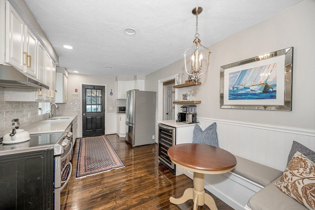 21 Sherwood Road Wilmington, MA 01887 - Photo 10 of 42 a living room with stainless steel appliances kitchen island granite countertop furniture and a chandelier