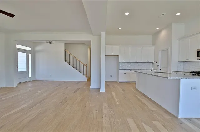 a kitchen with white cabinets and stainless steel appliances