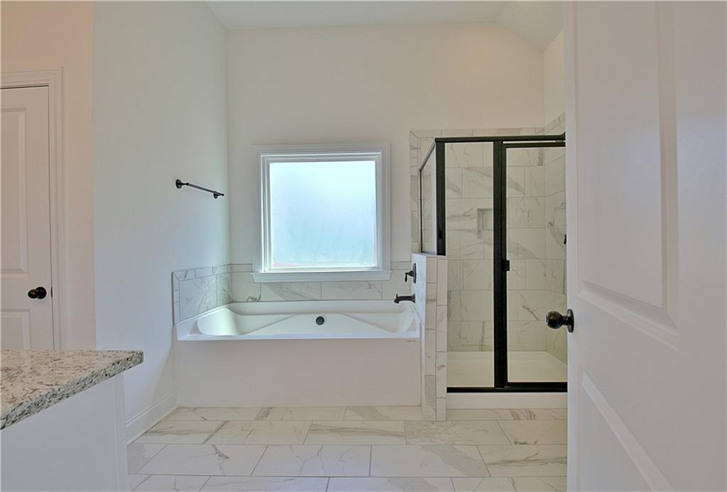 115 Rutland Court Senoia, GA 30276 - Photo 28 of 69 a bathroom with a granite countertop bathtub shower and sink