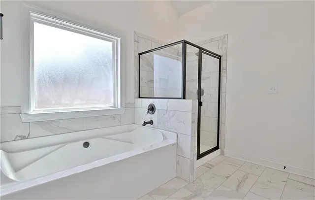 a view of a hallway with wooden floor and entryway