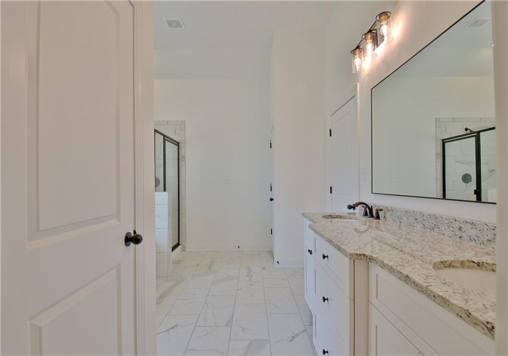 115 Rutland Court Senoia, GA 30276 - Photo 33 of 69 a bathroom with a granite countertop sink and a mirror