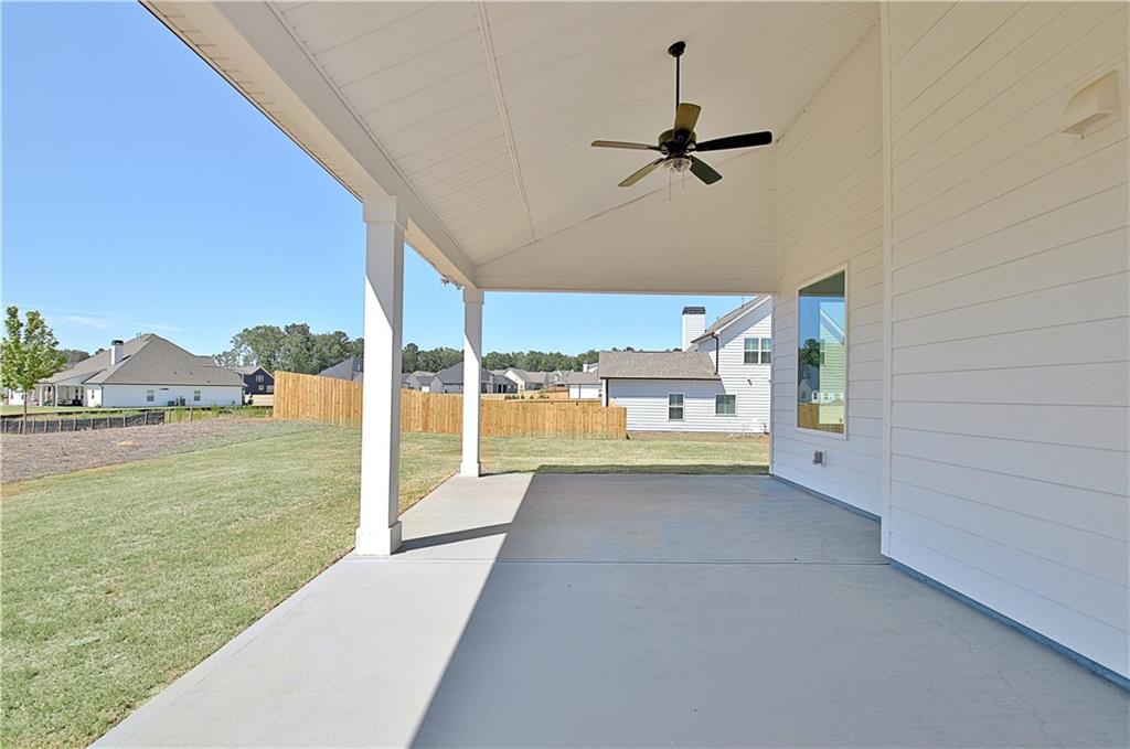 115 Rutland Court Senoia, GA 30276 - Photo 57 of 69 a view of a living room with a floor to ceiling window and a lake view