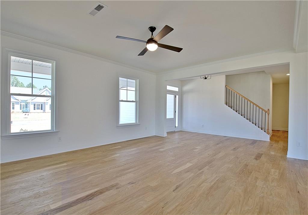 115 Rutland Court Senoia, GA 30276 - Photo 10 of 69 a view of empty room with wooden floor and fan