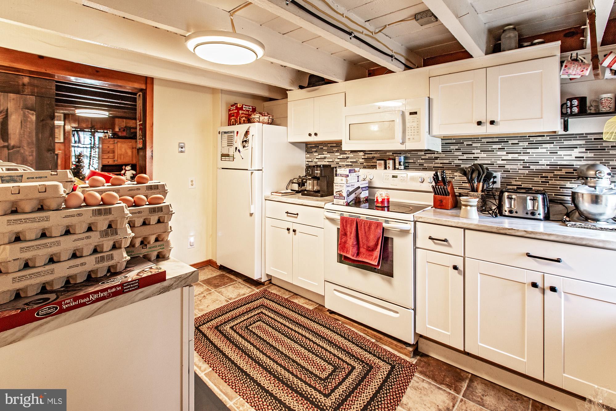 8 Water Street Alloway, NJ 08001 - Photo 6 of 16 a kitchen with stainless steel appliances granite countertop a stove and a refrigerator