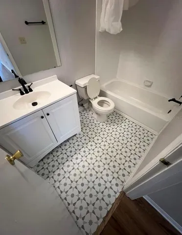 a bathroom with a sink a toilet and mirror