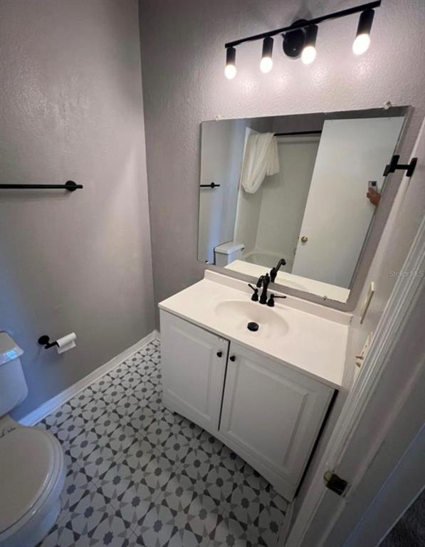 1081 South Hiawassee Road, Unit 721 Orlando, FL 32835 - Photo 12 of 18 a bathroom with a sink a toilet and mirror