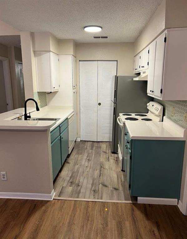 1081 South Hiawassee Road, Unit 721 Orlando, FL 32835 - Photo 4 of 18 a kitchen with kitchen island a sink stove and refrigerator