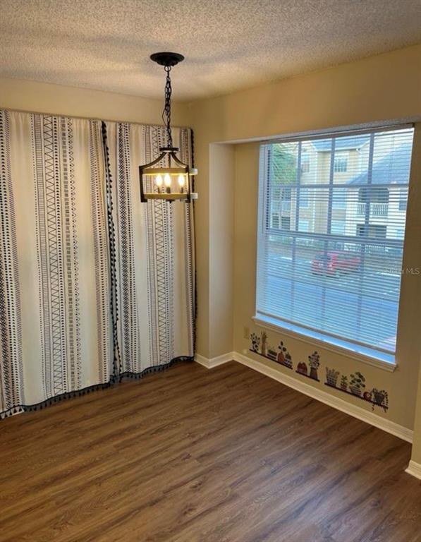 1081 South Hiawassee Road, Unit 721 Orlando, FL 32835 - Photo 7 of 18 a view of a room with wooden floor and windows