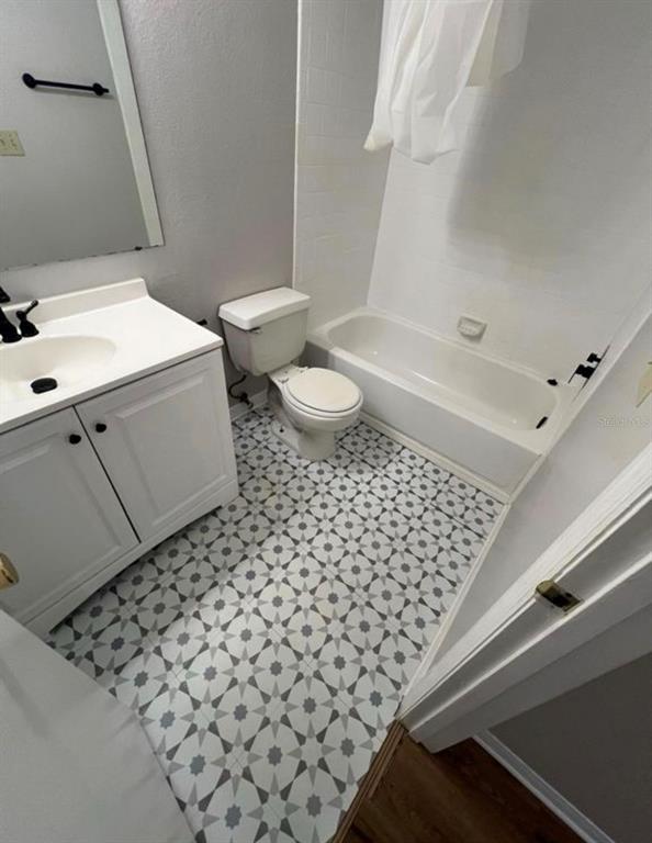 1081 South Hiawassee Road, Unit 721 Orlando, FL 32835 - Photo 10 of 18 a bathroom with a sink a toilet and a shower