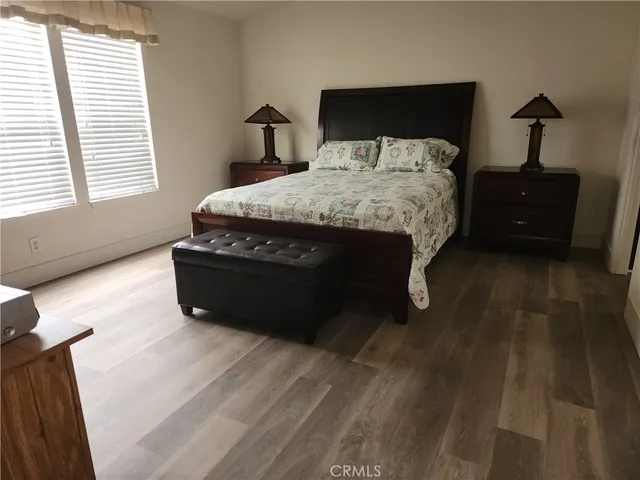 a bed sitting in a bedroom next to a window