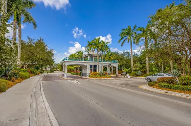 a view of a house with a yard and potted plants
