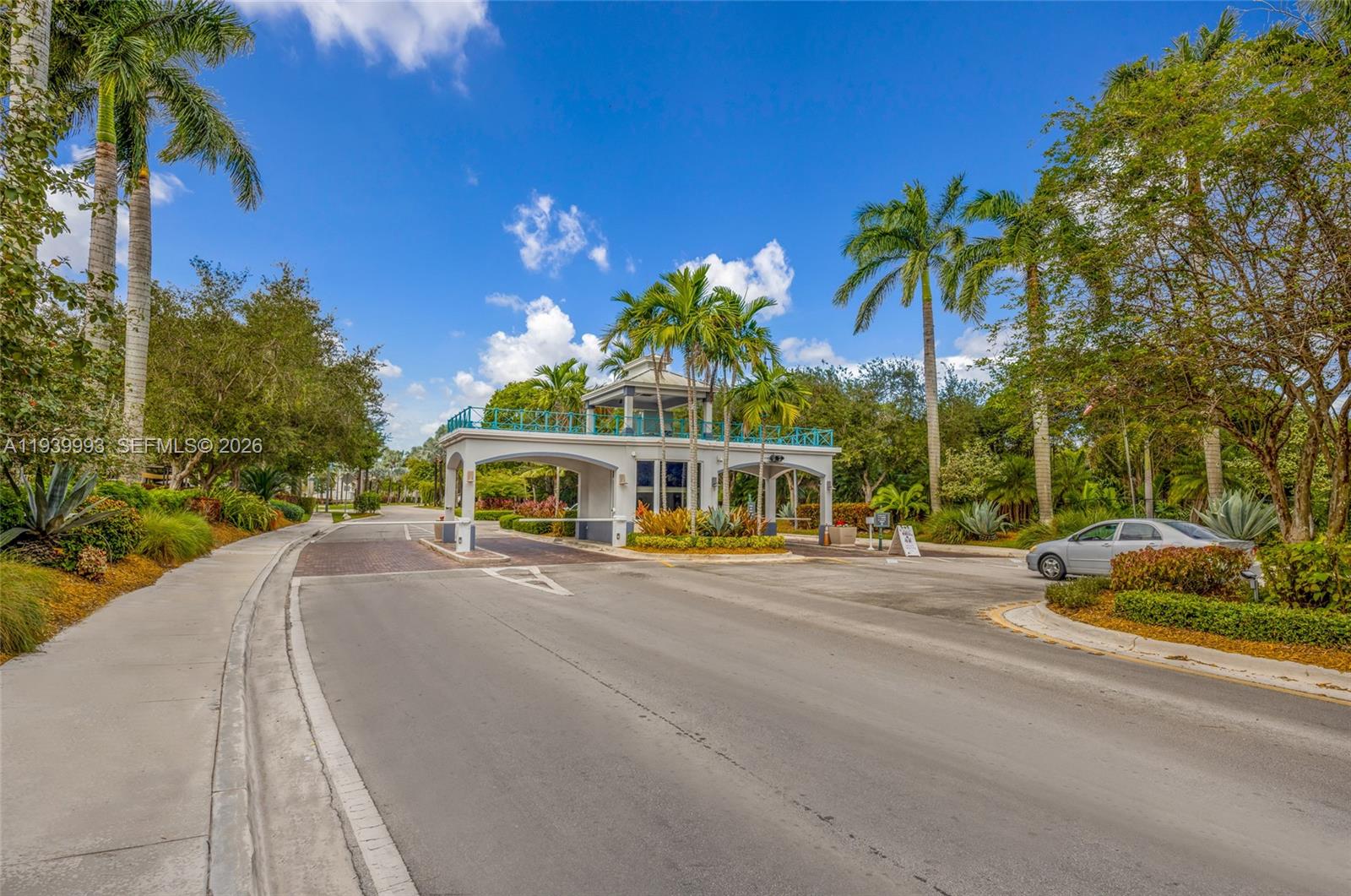 a view of a house with a yard and potted plants