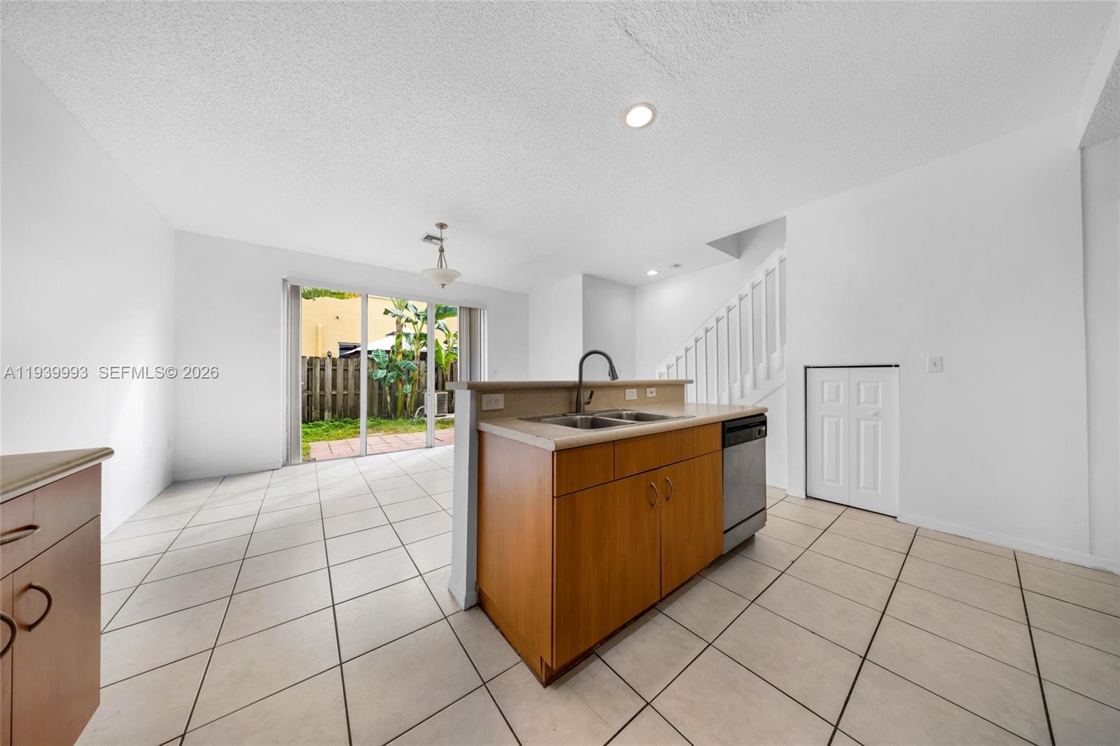 951 Northeast 42nd Terrace, Unit 951 Homestead, FL 33033 - Photo 14 of 30 a kitchen with stainless steel appliances granite countertop a sink and a stove