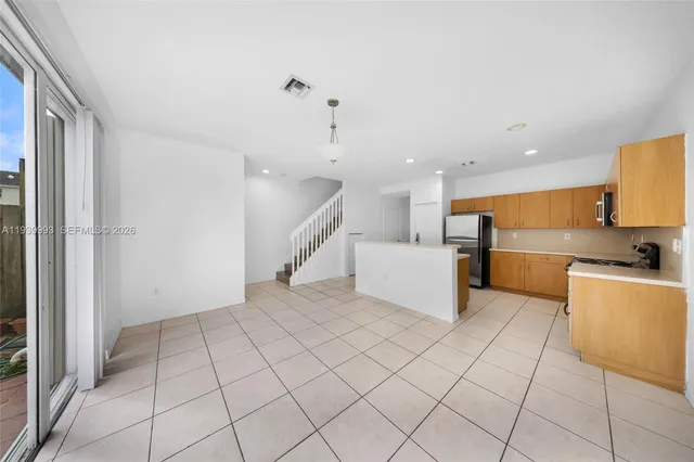 a view of a kitchen with microwave and white cabinets
