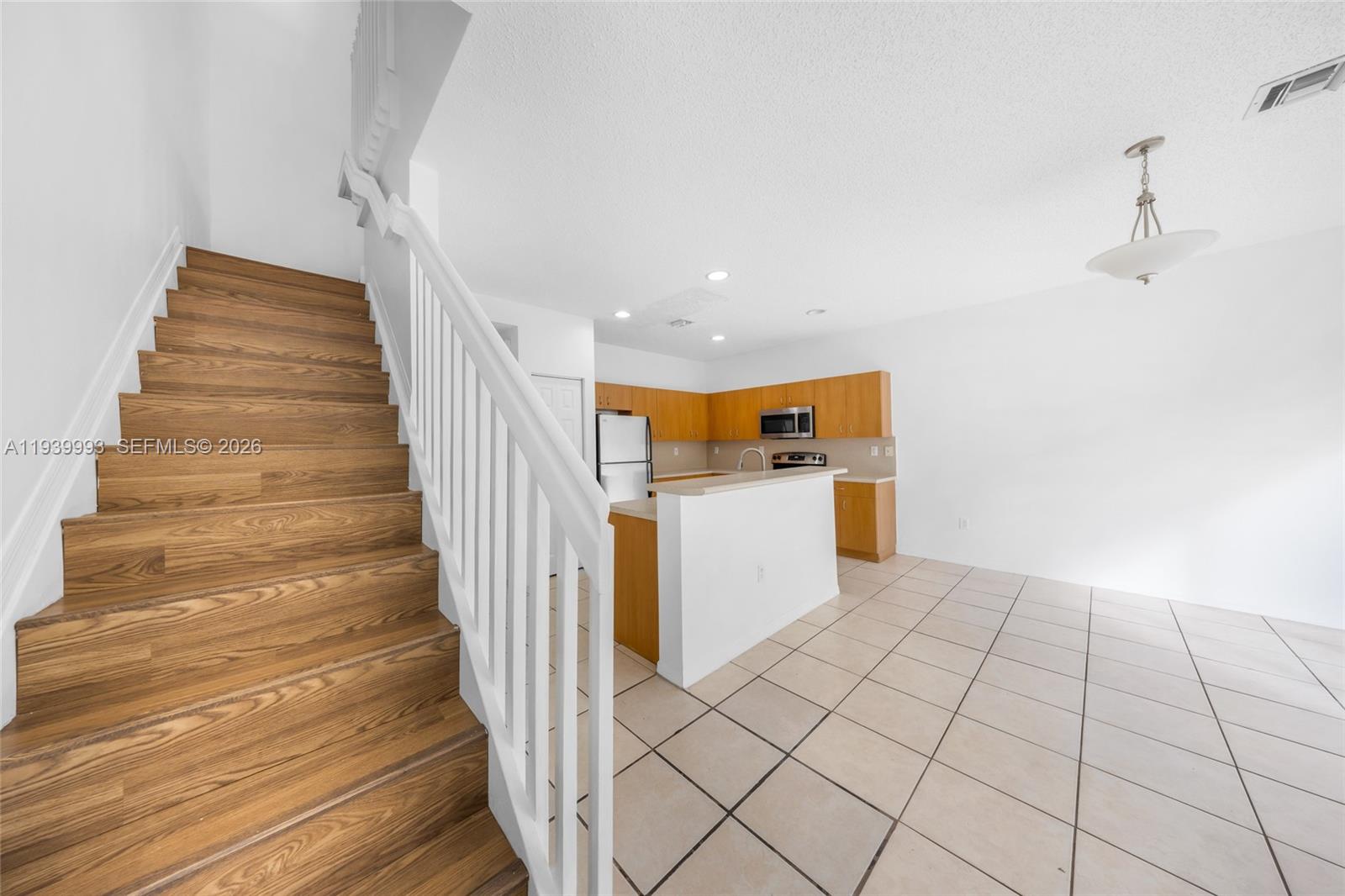 951 Northeast 42nd Terrace, Unit 951 Homestead, FL 33033 - Photo 19 of 30 a view of entryway and hall with wooden floor