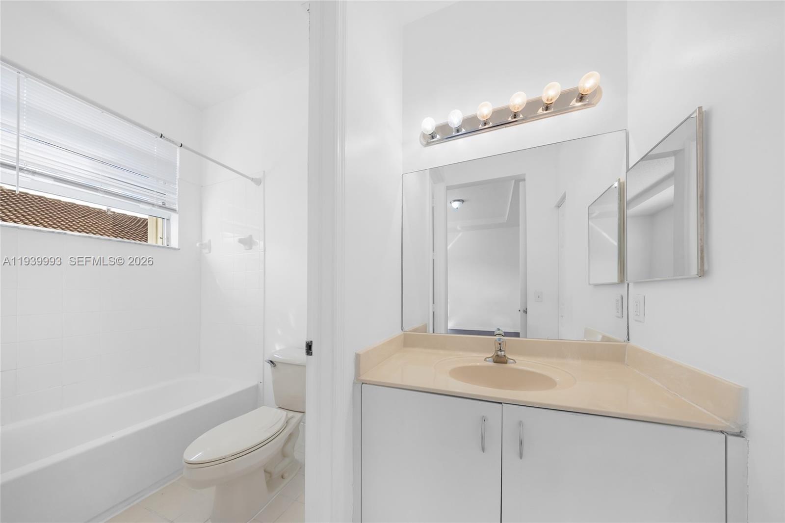 951 Northeast 42nd Terrace, Unit 951 Homestead, FL 33033 - Photo 21 of 30 a bathroom with a granite countertop sink a toilet and shower