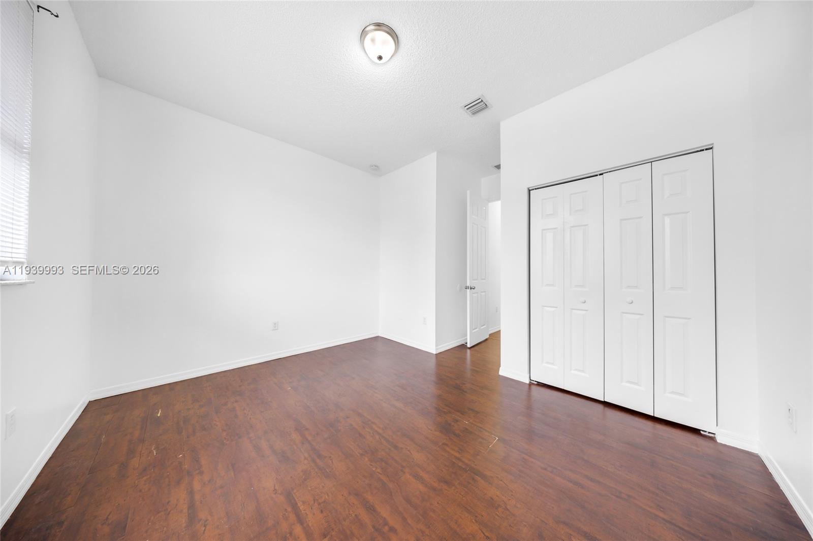 951 Northeast 42nd Terrace, Unit 951 Homestead, FL 33033 - Photo 28 of 30 a view of an empty room with wooden floor