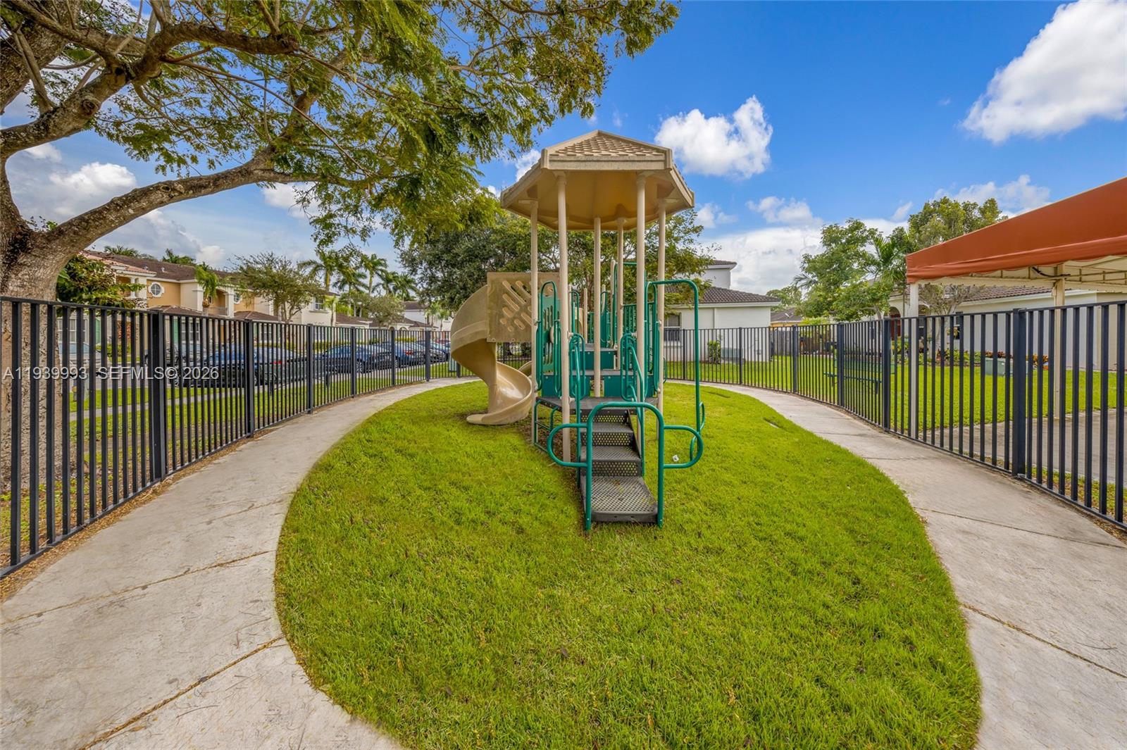 951 Northeast 42nd Terrace, Unit 951 Homestead, FL 33033 - Photo 30 of 30 a view of a swimming pool with a patio and a garden