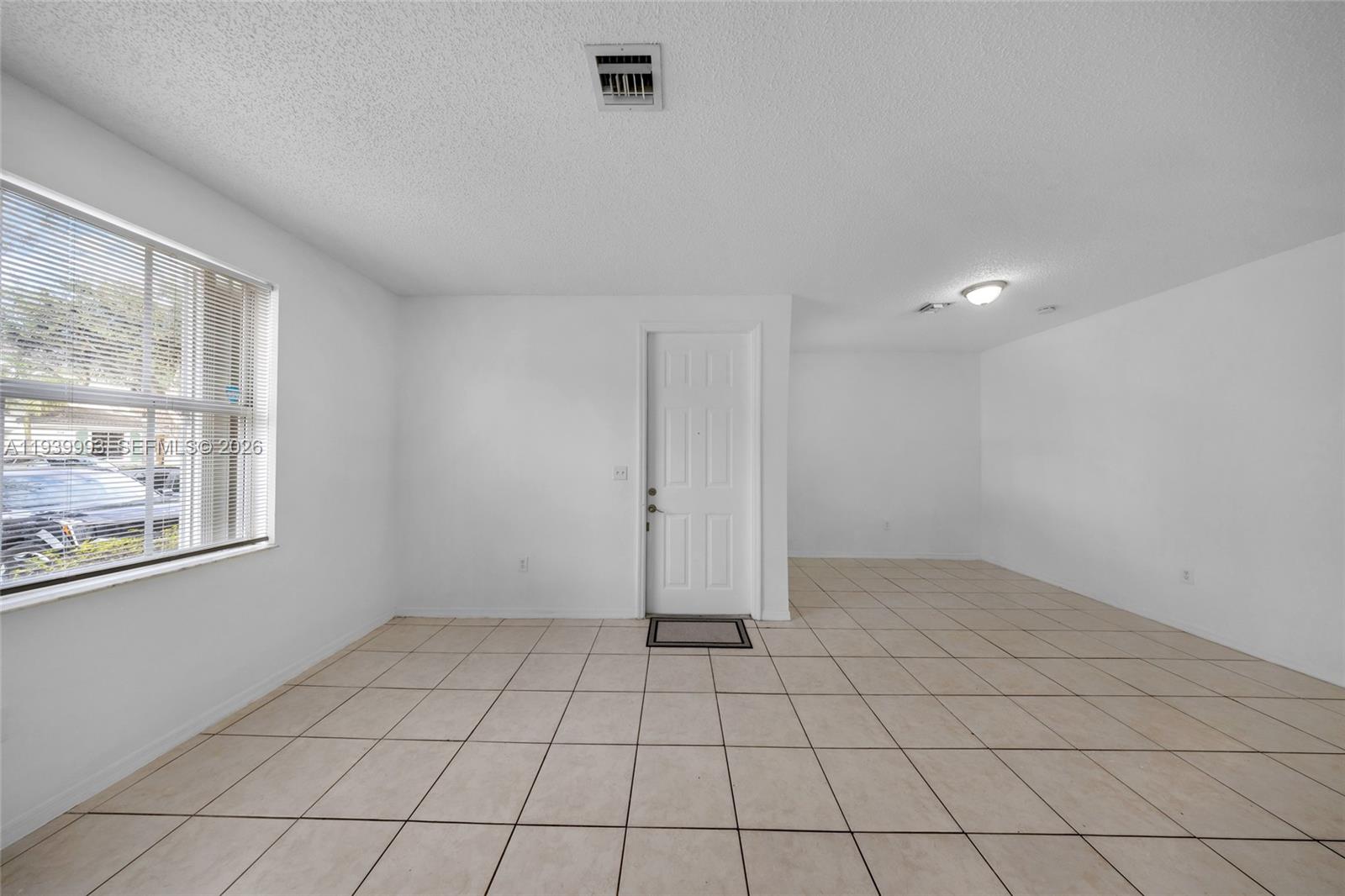 951 Northeast 42nd Terrace, Unit 951 Homestead, FL 33033 - Photo 7 of 30 a view of an empty room and window