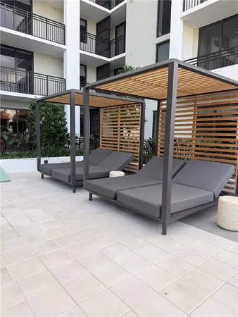 a view of a patio with a table and chairs
