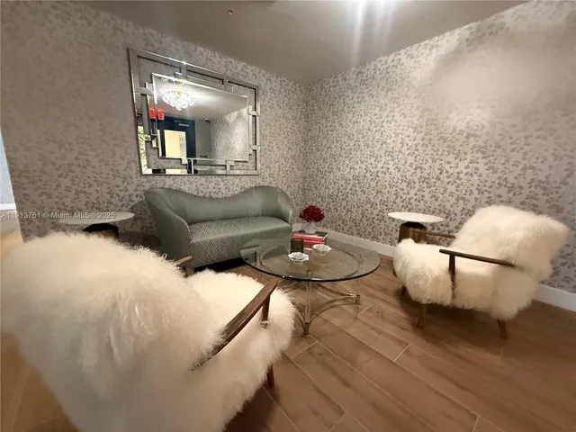 a living room with furniture and a mirror
