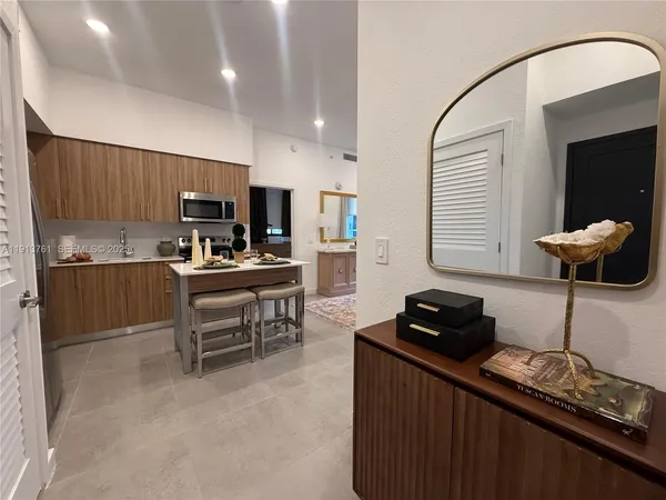a kitchen with a refrigerator and a stove top oven