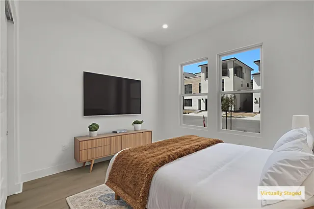 a bedroom with a bed and a flat screen tv