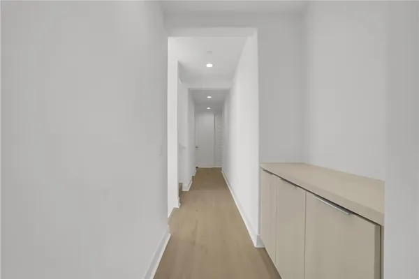 a view of a hallway with wooden floor