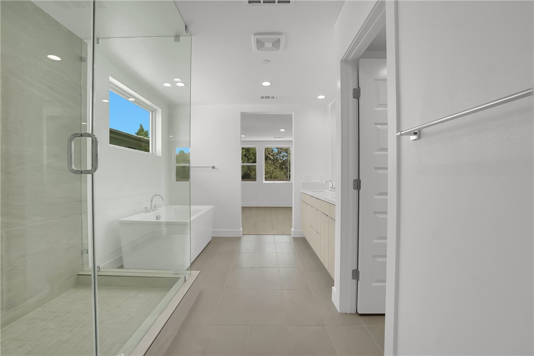 168 Creation Irvine, CA 92618 - Photo 28 of 59 a bathroom with a bathtub and shower
