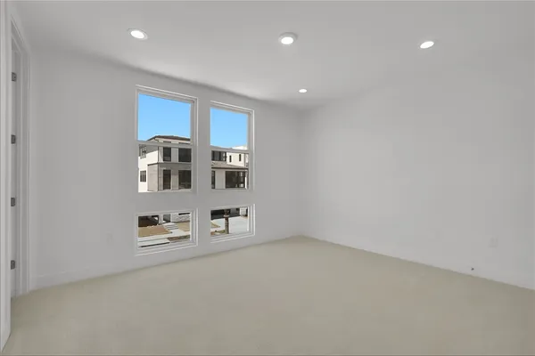 a bedroom with a large bed and a potted plant