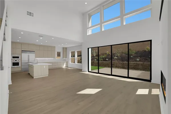 a view of a kitchen with large windows