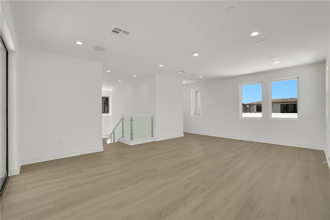 168 Creation Irvine, CA 92618 - Photo 46 of 59 a view of an empty room with wooden floor