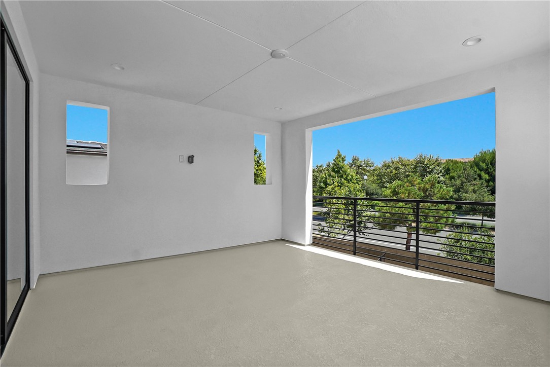 168 Creation Irvine, CA 92618 - Photo 49 of 59 an empty room with wooden floor and windows