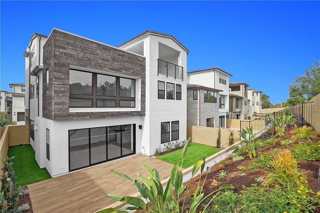 168 Creation Irvine, CA 92618 - Photo 57 of 59 a front view of a house with a yard