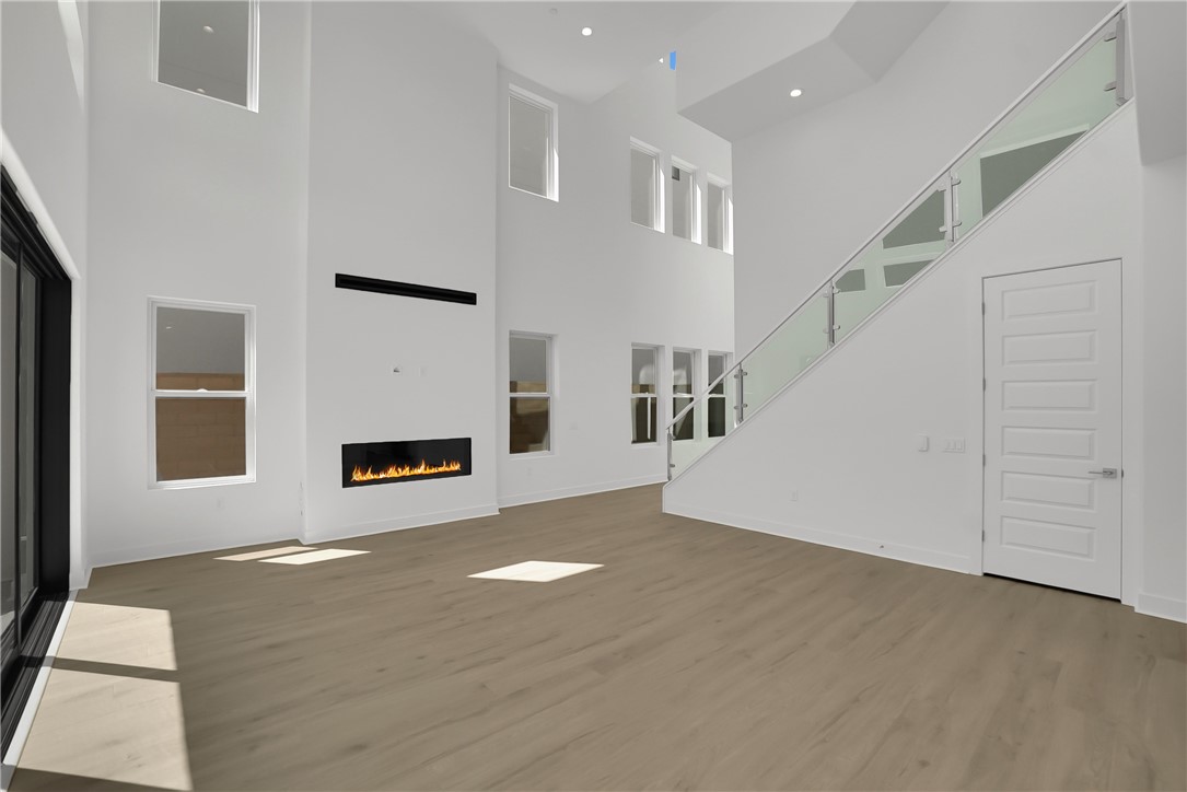 168 Creation Irvine, CA 92618 - Photo 8 of 59 a view of a livingroom with wooden floor and a ceiling fan