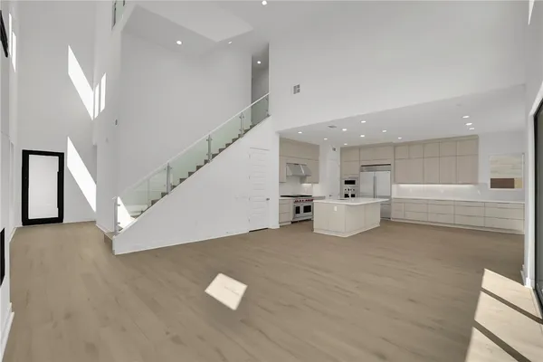 a view of a kitchen with furniture and stairs