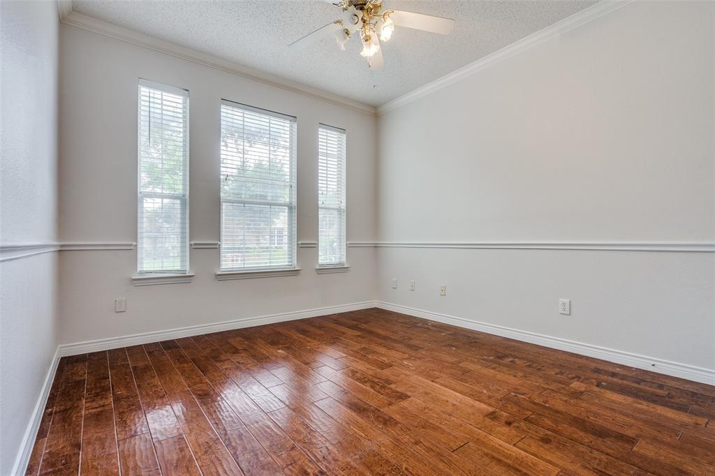 3421 Neiman Road Plano, TX 75025 - Photo 20 of 40 Empty room with ceiling fan, hardwood / wood-style floors, a textured ceiling, and ornamental molding
