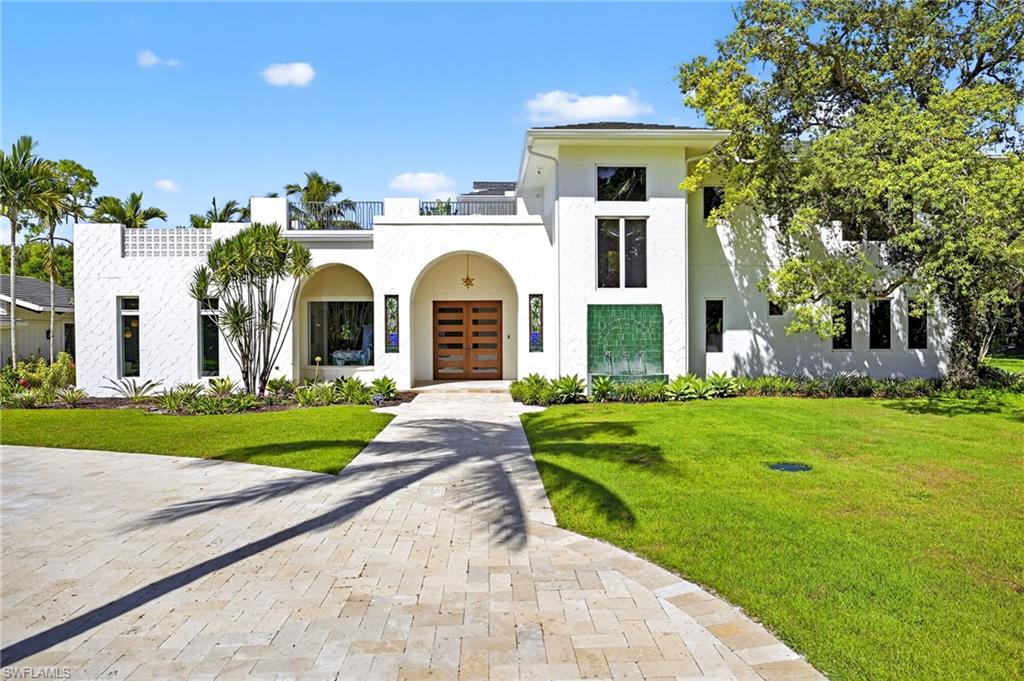 111 Caribbean Road Naples, FL 34108 - Photo 10 of 50 a front view of house with yard and green space