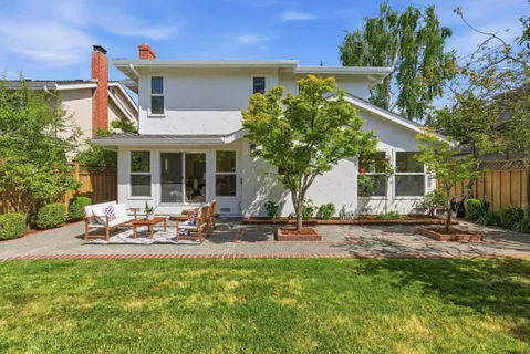 a front view of a house with sitting area and garden