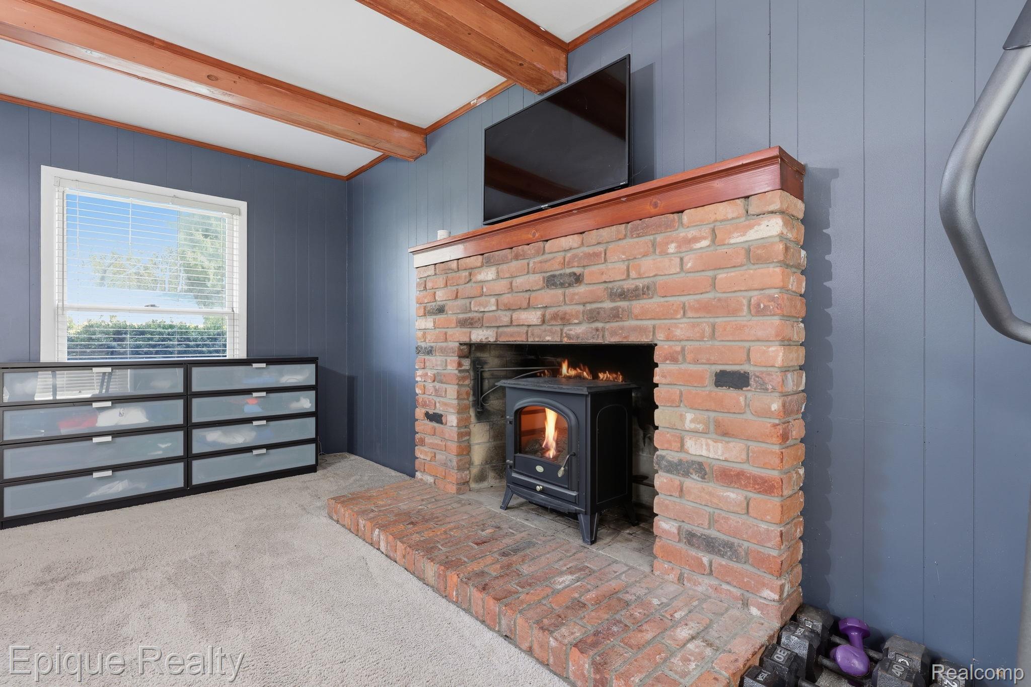 7441 Honeysuckle Road West Bloomfield, MI 48324 - Photo 21 of 35 Detailed view of wooden walls, beamed ceiling, and carpet floors