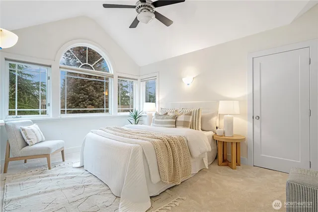 a bedroom with a bed and a large mirror