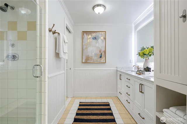 a bathroom with a double vanity sink and a mirror
