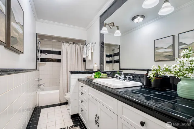 a bathroom with a double vanity sink a mirror and a bathtub
